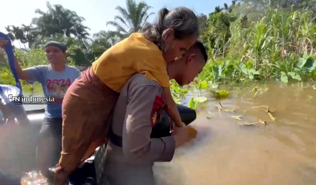 Ditpolairud Polda Riau Evakuasi Warga Terdampak Banjir Dengan Sigap Gendong Warga ke Posko Pengungsian